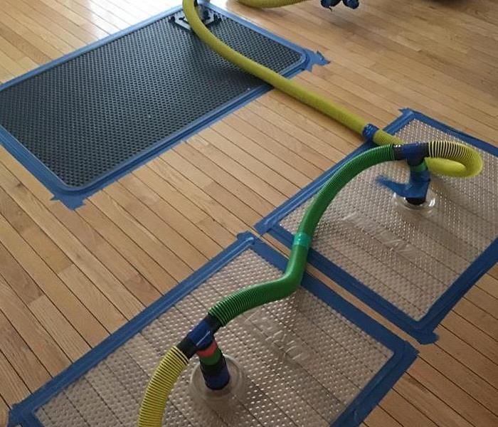 3 drying mats on hard wood flooring